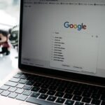 A close-up shot of a laptop displaying a Google search page with related searches visible.